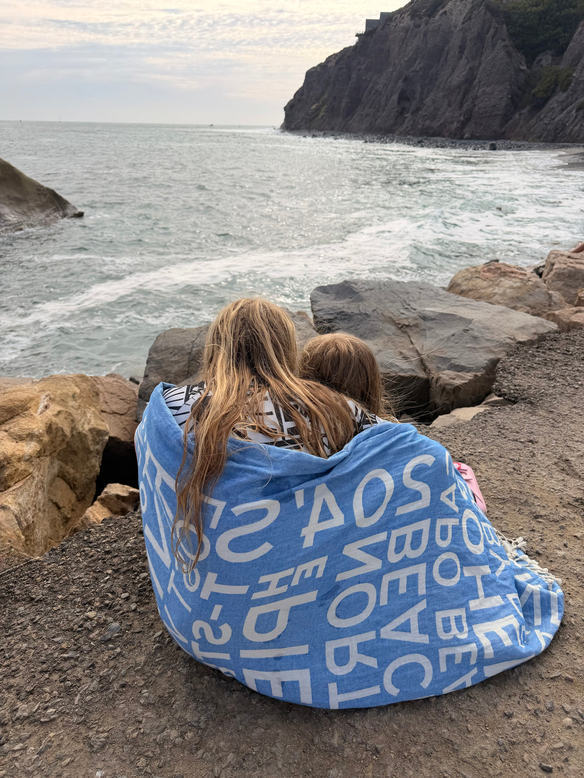 South OC Beaches Turkish cotton beach towel as a cozy wrap for kids by the ocean