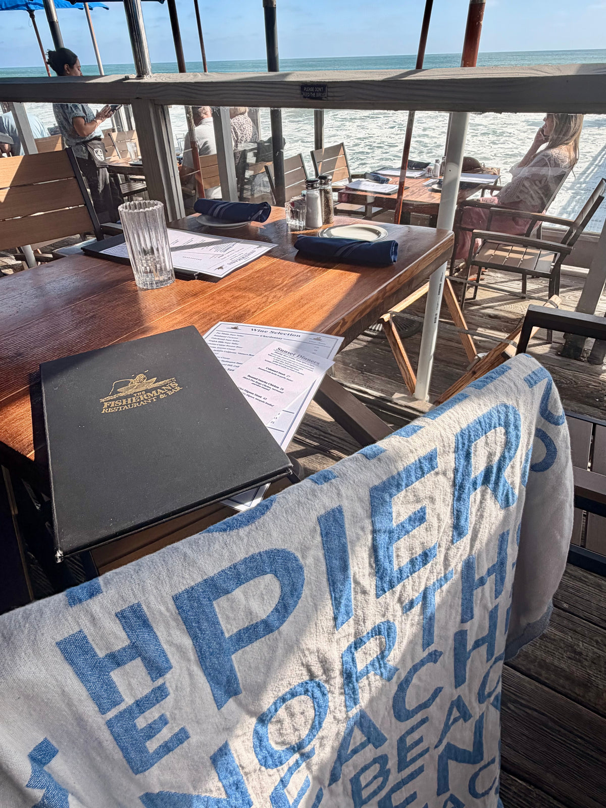 South OC Beaches Turkish cotton beach towel draped at a restaurant on the pier in San Clemente