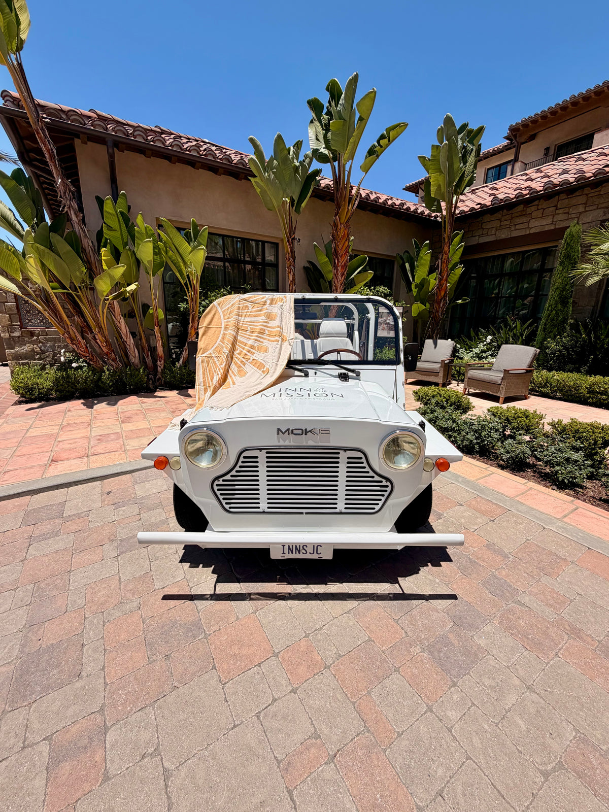 Deco Sunburst Turkish cotton beach towel styled on a vintage convertible In San Juan Capistrano