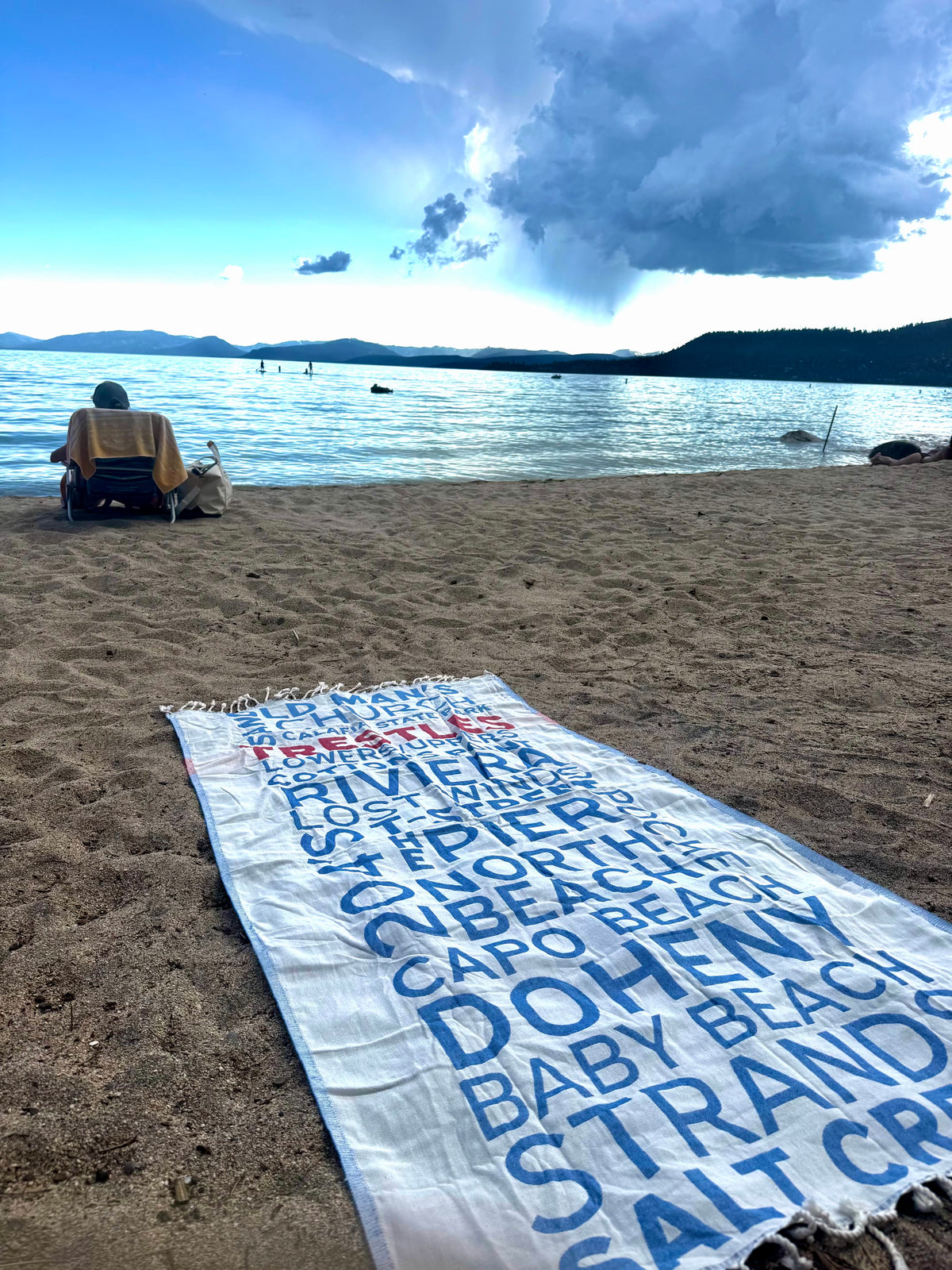 South OC Beaches Turkish cotton beach towel laid out on the sand by Lake Tahoe