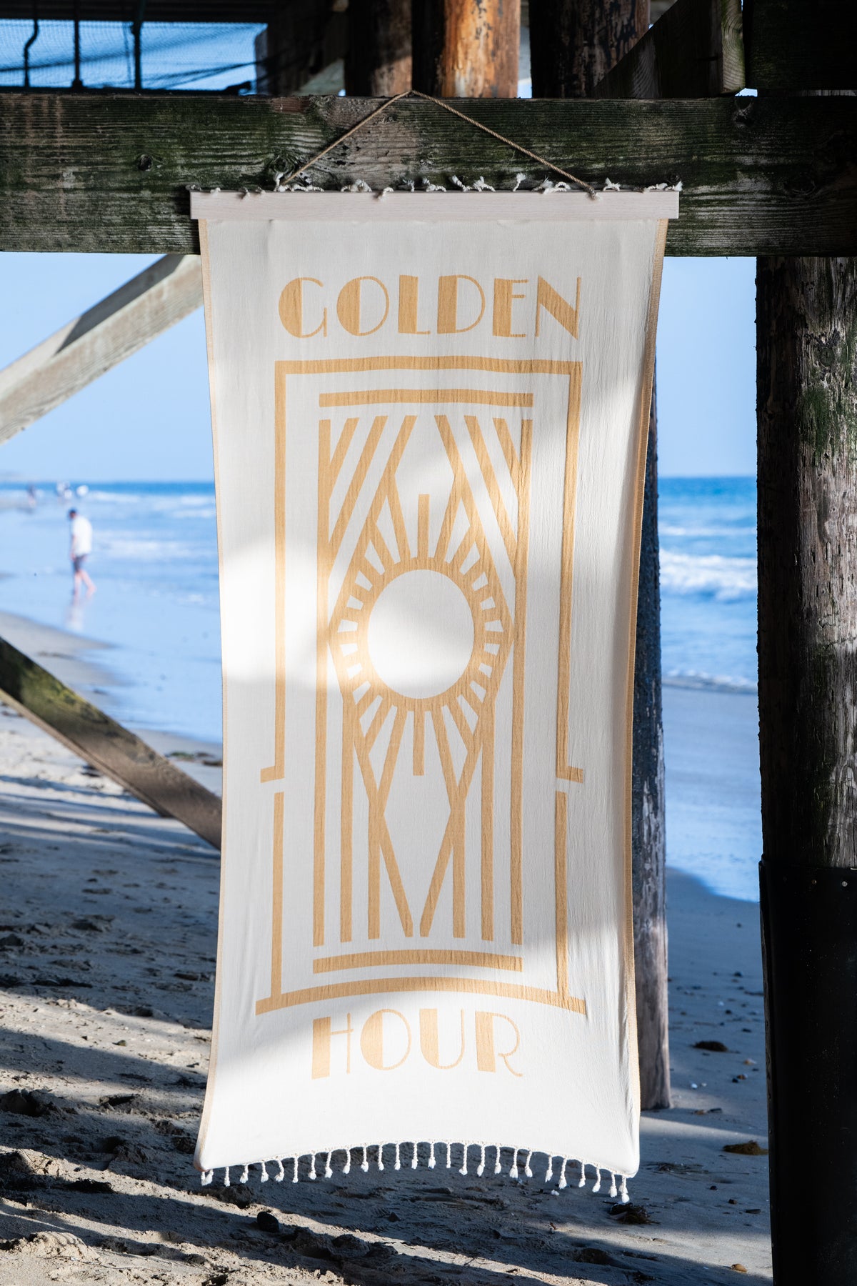 Golden Hour Turkish cotton beach towel hanging by the beach in San Clemente